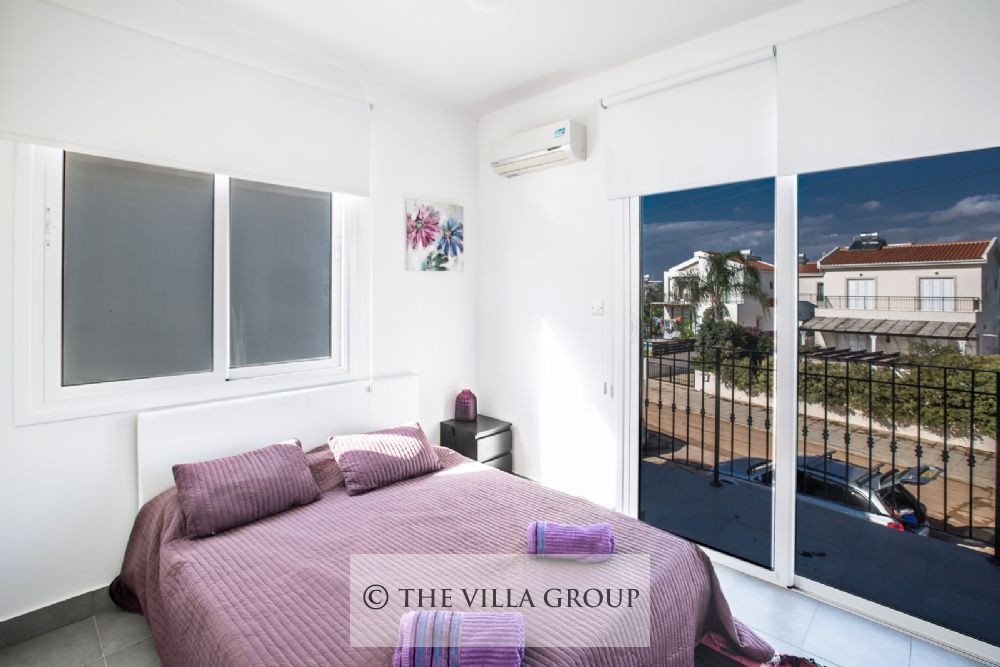 First bedroom with a double bed and balcony