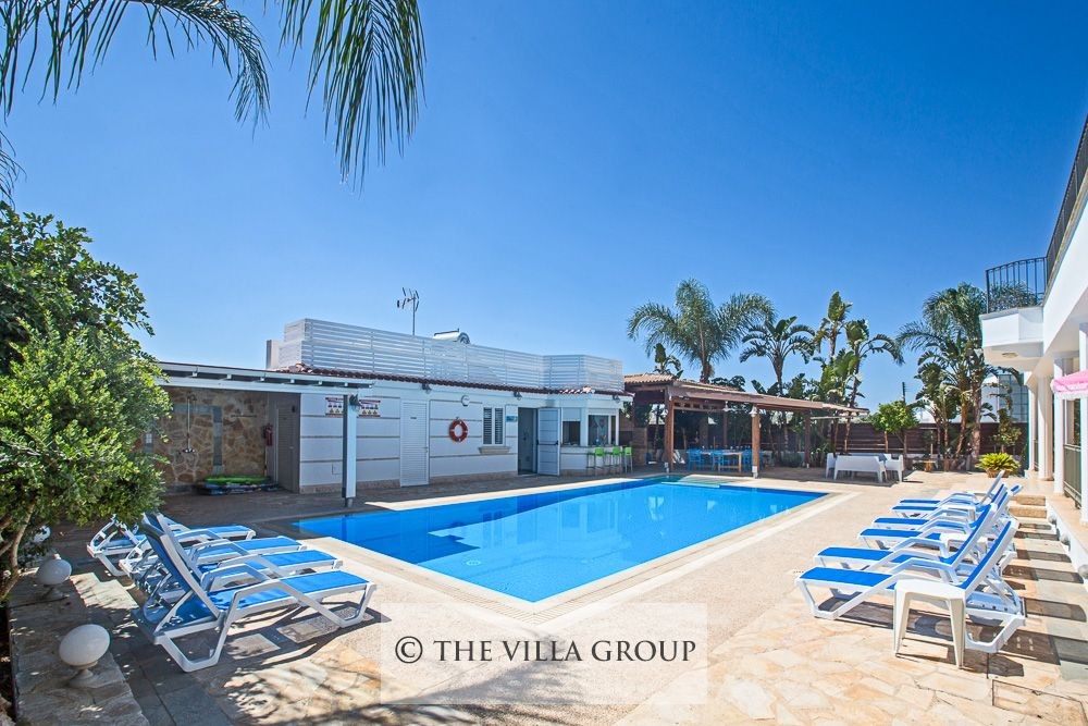 Private swimming pool surrounded by sunbeds