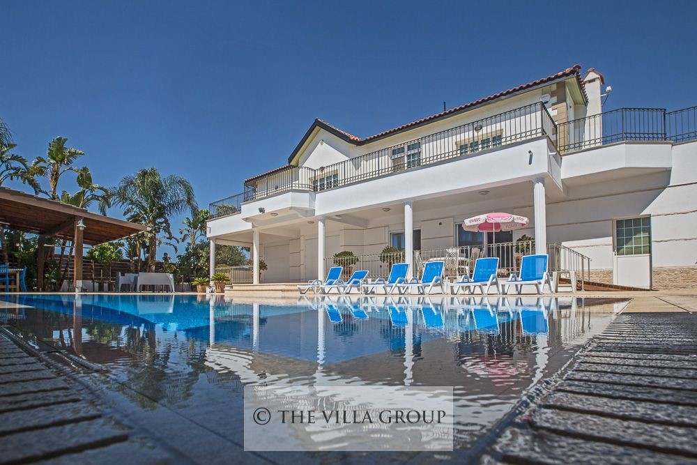 Private swimming pool surrounded by sunbeds