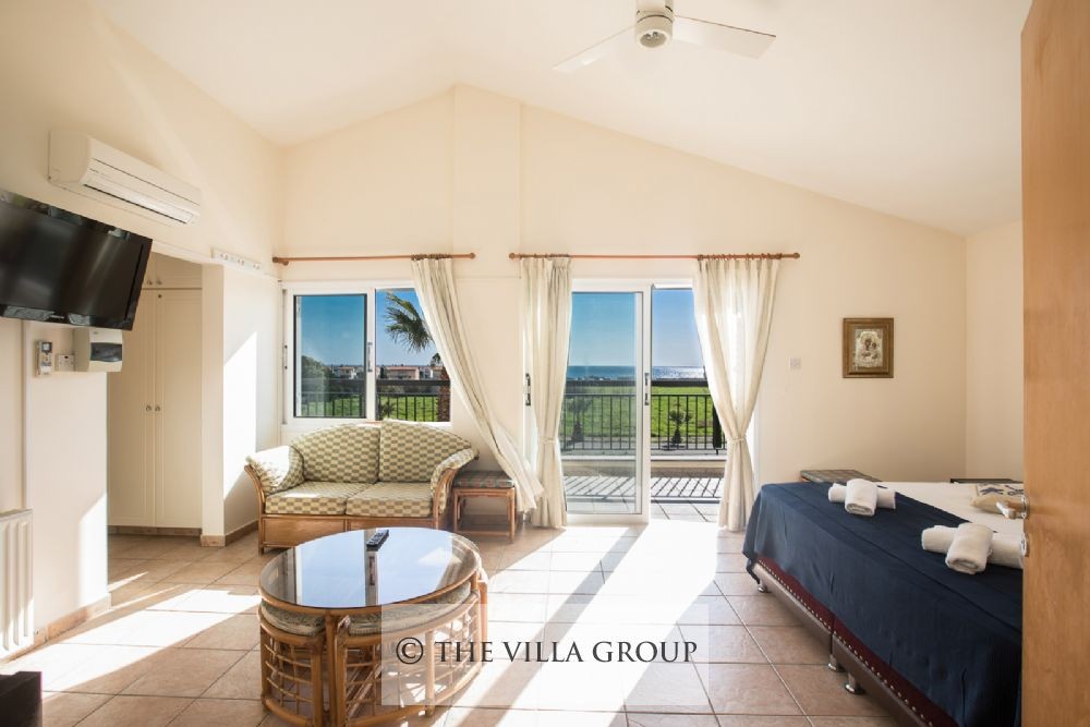 Master bedroom with sofa and sea view balcony