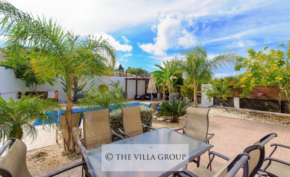 Outside dining table next to the swimming pool