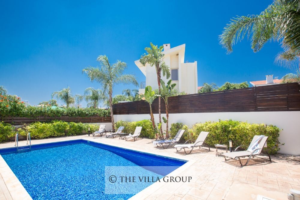 Swimmin pool surrounded by sun loungers