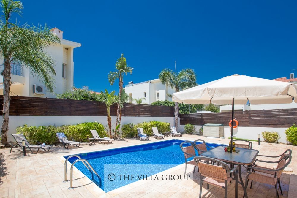 Outside dining table next to the swimmin pool