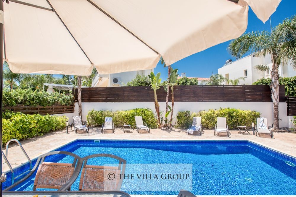 Swimmin pool surrounded by sun loungers