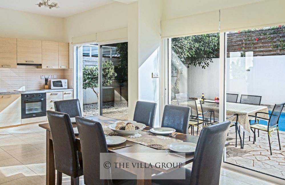 Dining table for 6 and patio doors with direct access to the swimming pool