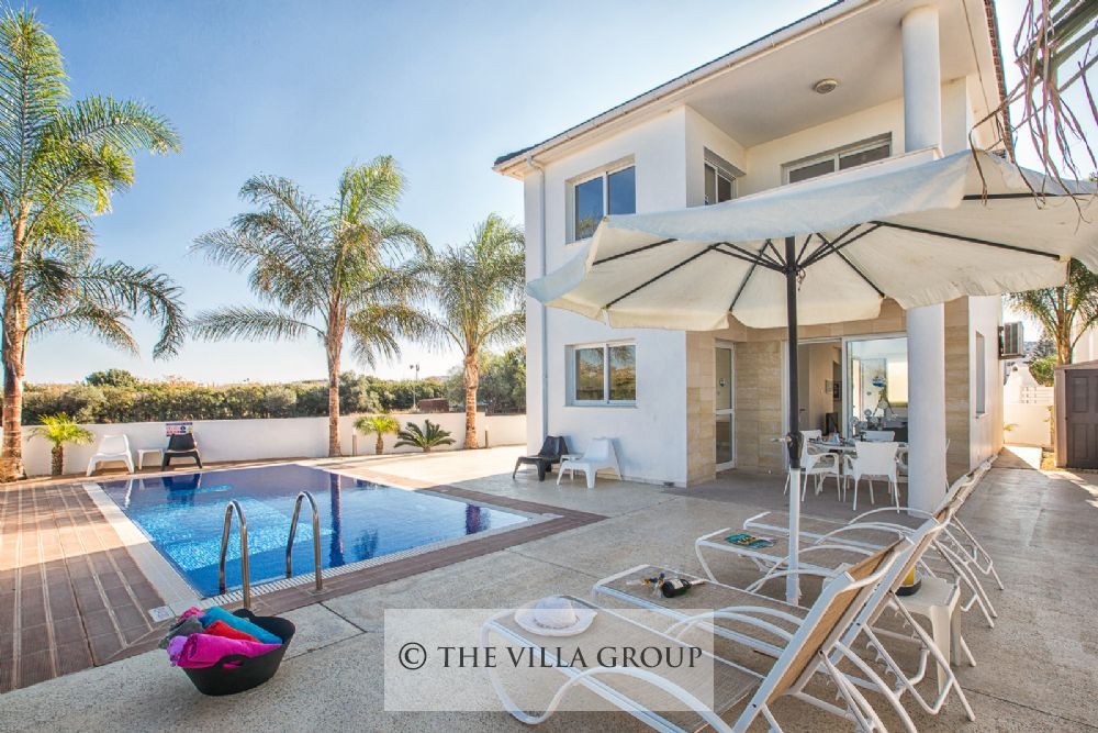 Swimming pool surrounded by sun beds
