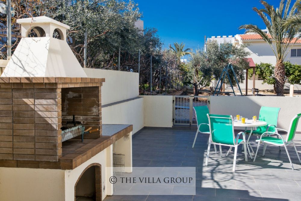 Built-in barbecue with outside dining furniture