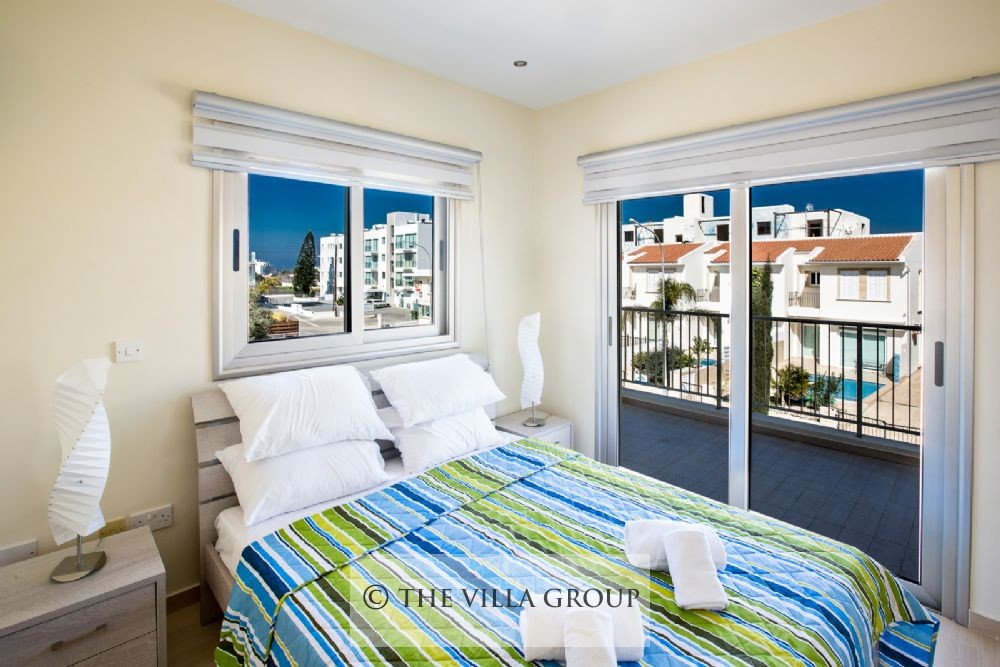 Double bedroom with patio doors leading to a balcony