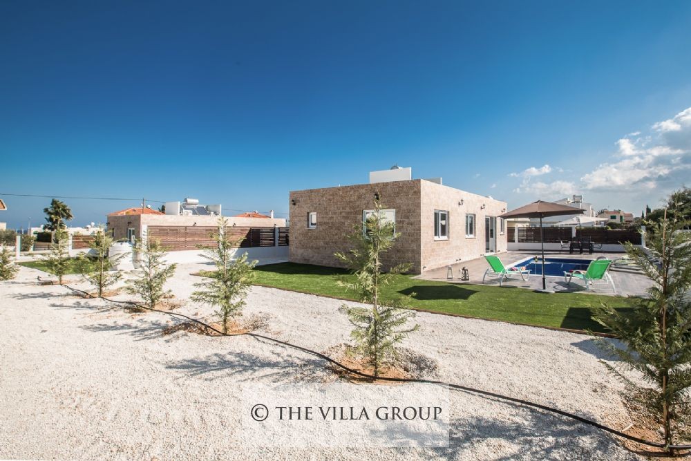 A spacious garden area surrounds the villa