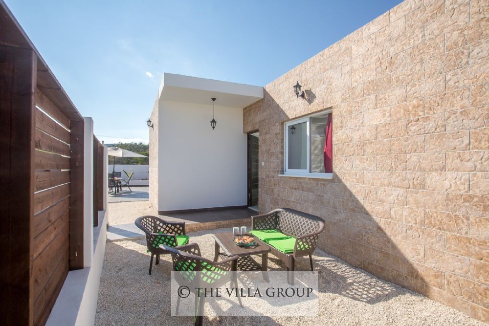 Another outside patio table with villa entrance