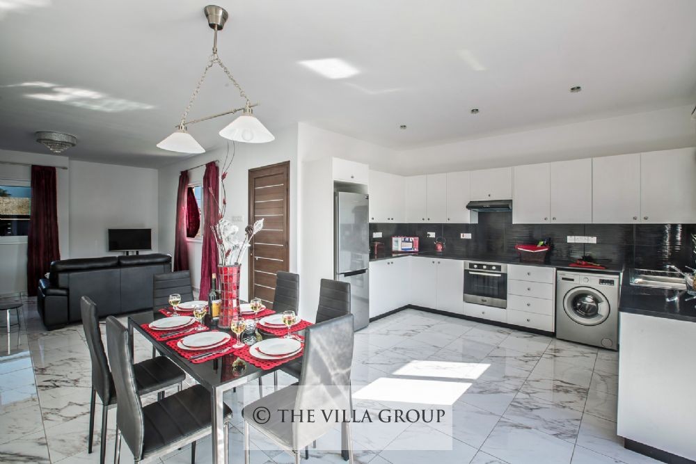 Open plan kitchen, dining and living area with villa entrance