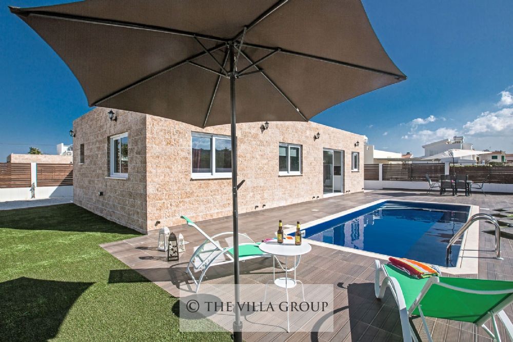 Furnished outside area with artificial lawn