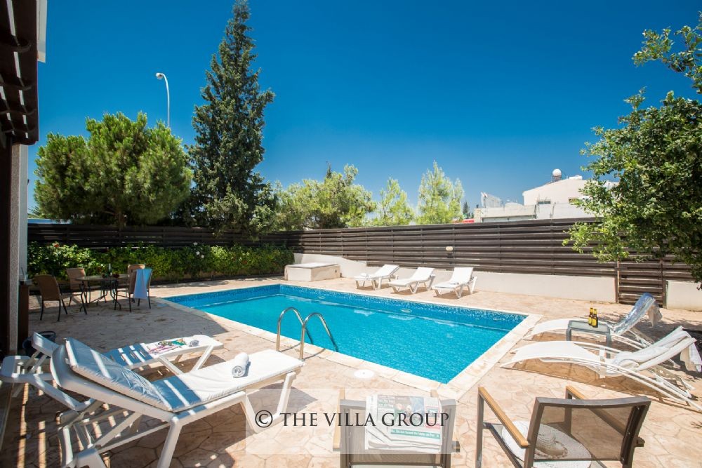 Swimming pool surrounded by sun loungers