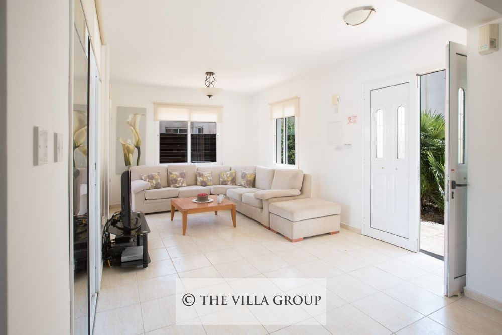 Living area with comfortable sofa and villa entrance