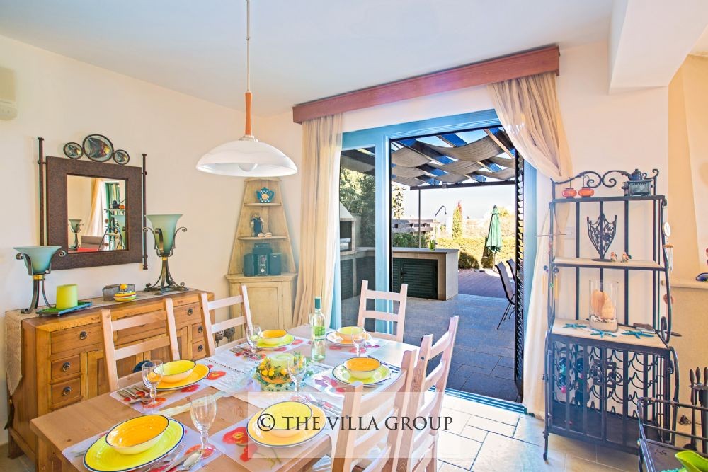 Dining area with patio doors leading to the swimming pool