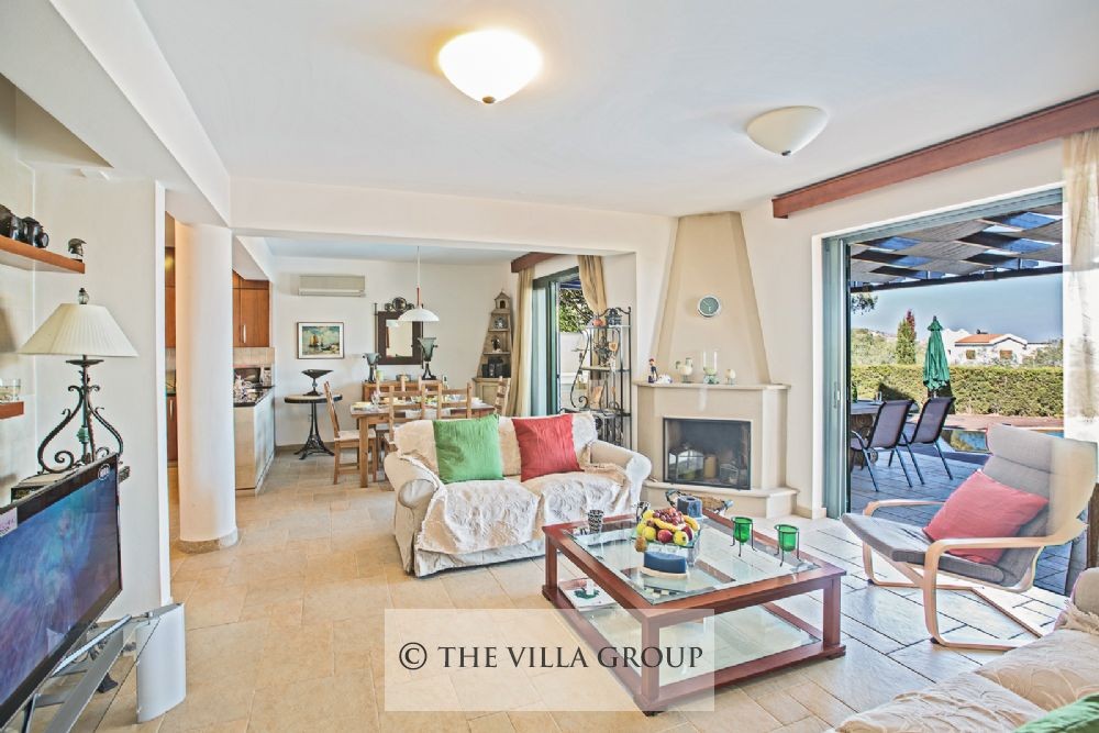 Spacious living area with comfortable sofas and patio doors leading outside