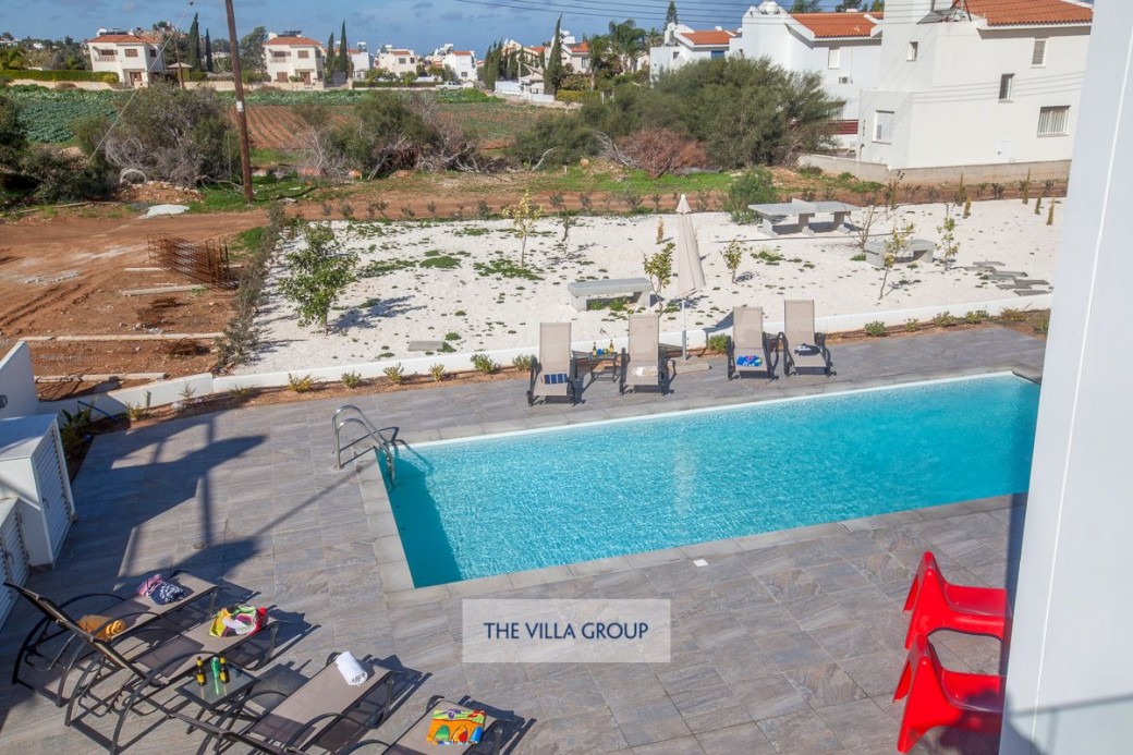 Private swimming pool surrounded by sun loungers