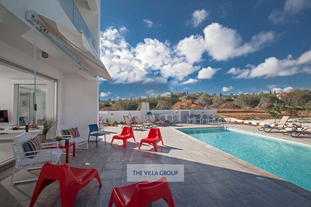 Private swimming pool surrounded by sun loungers