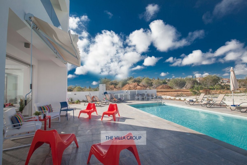 Private swimming pool surrounded by sun loungers