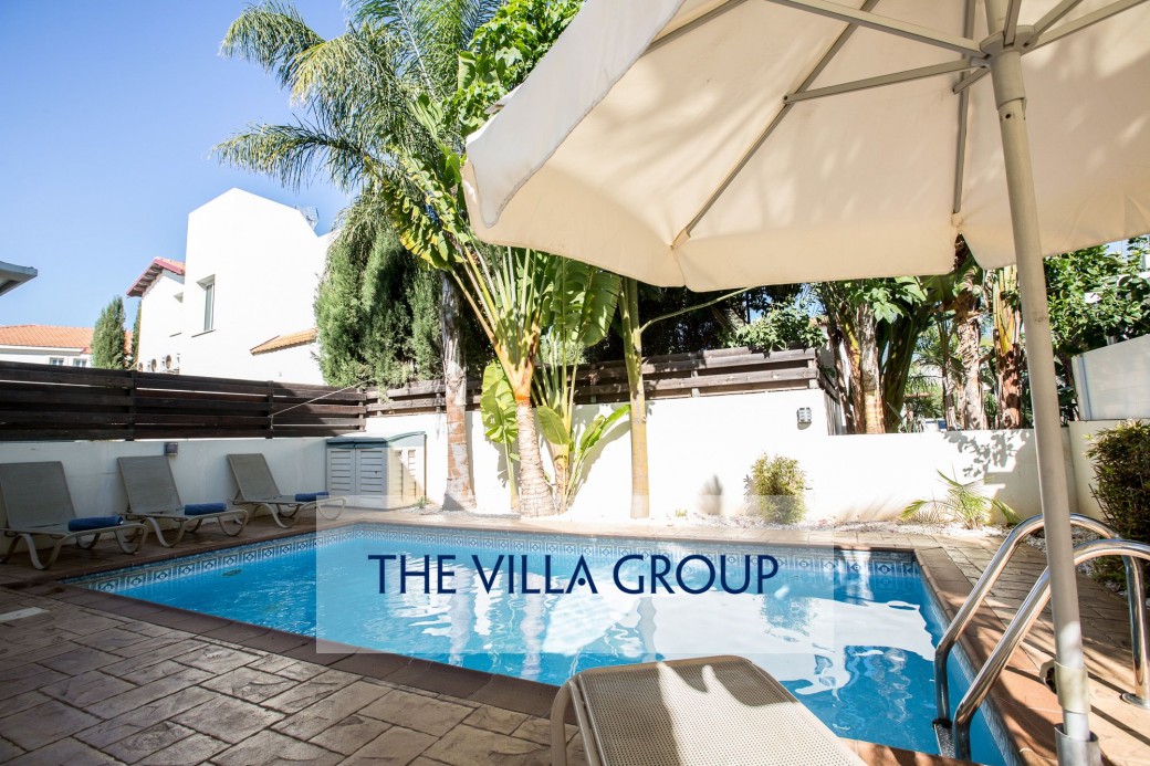 Private swimming pool surrounded by sunbeds for relaxing under the Cyprus sun