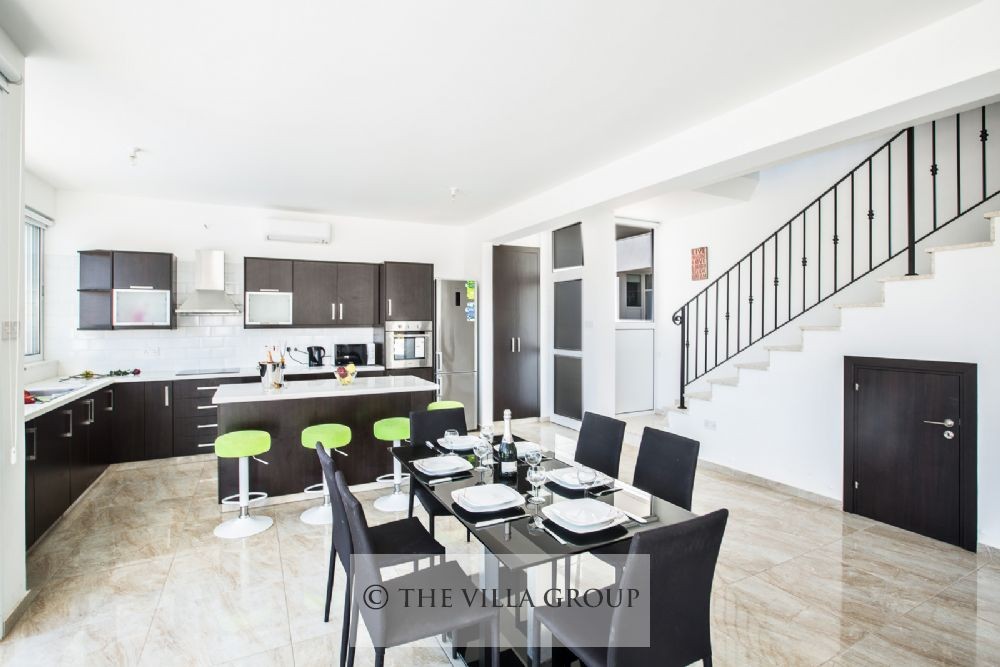 Dining table, kitchen and stairs to first floor