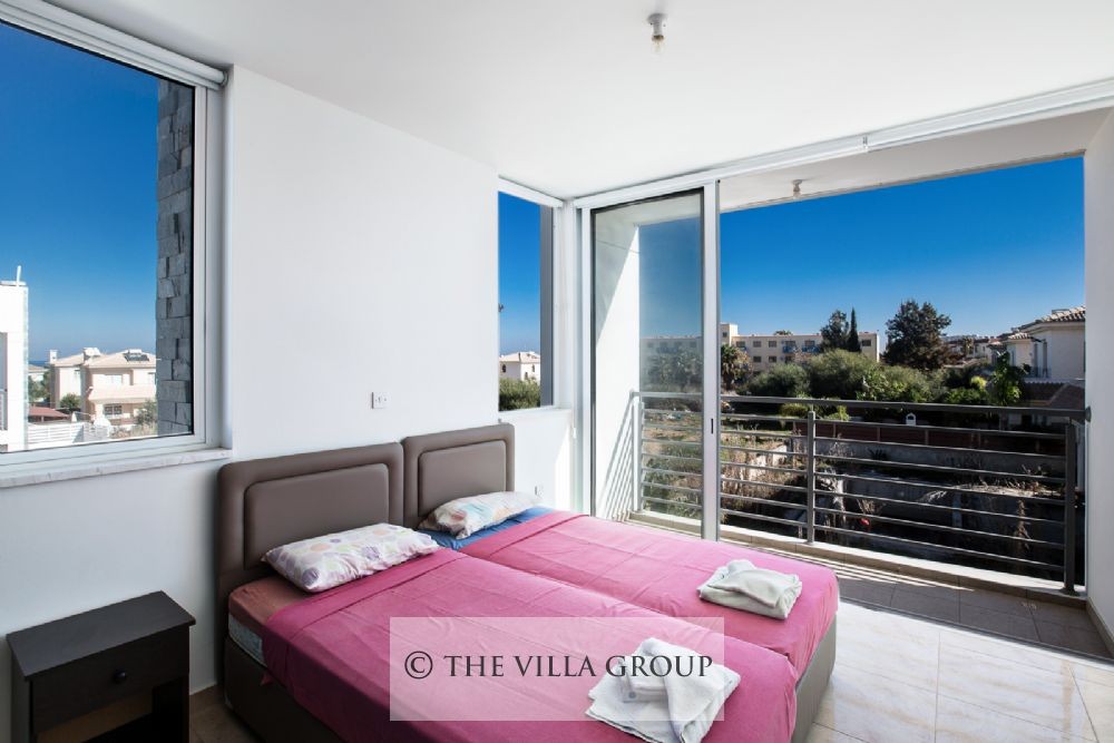 Second bedroom with twin beds and balcony