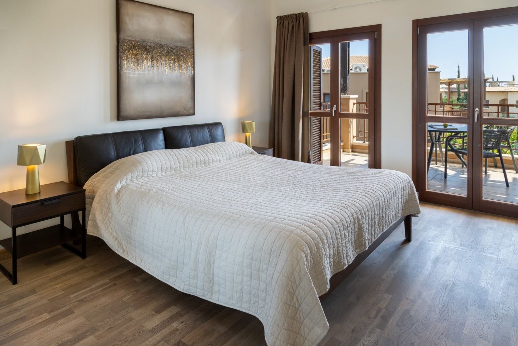 Master bedroom with doors leading to the balcony